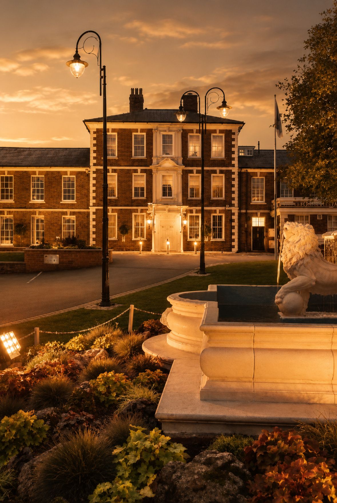 Evening view of a large building with decorative elements and streetlights.